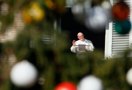 Pope Francis is framed by the Christmas tree as he leads the Angelus from the window of his studio overlooking St. Peter's Square at the Vatican Dec. 8, the feast of the Immaculate Conception. (CNS photo/Paul Haring) 