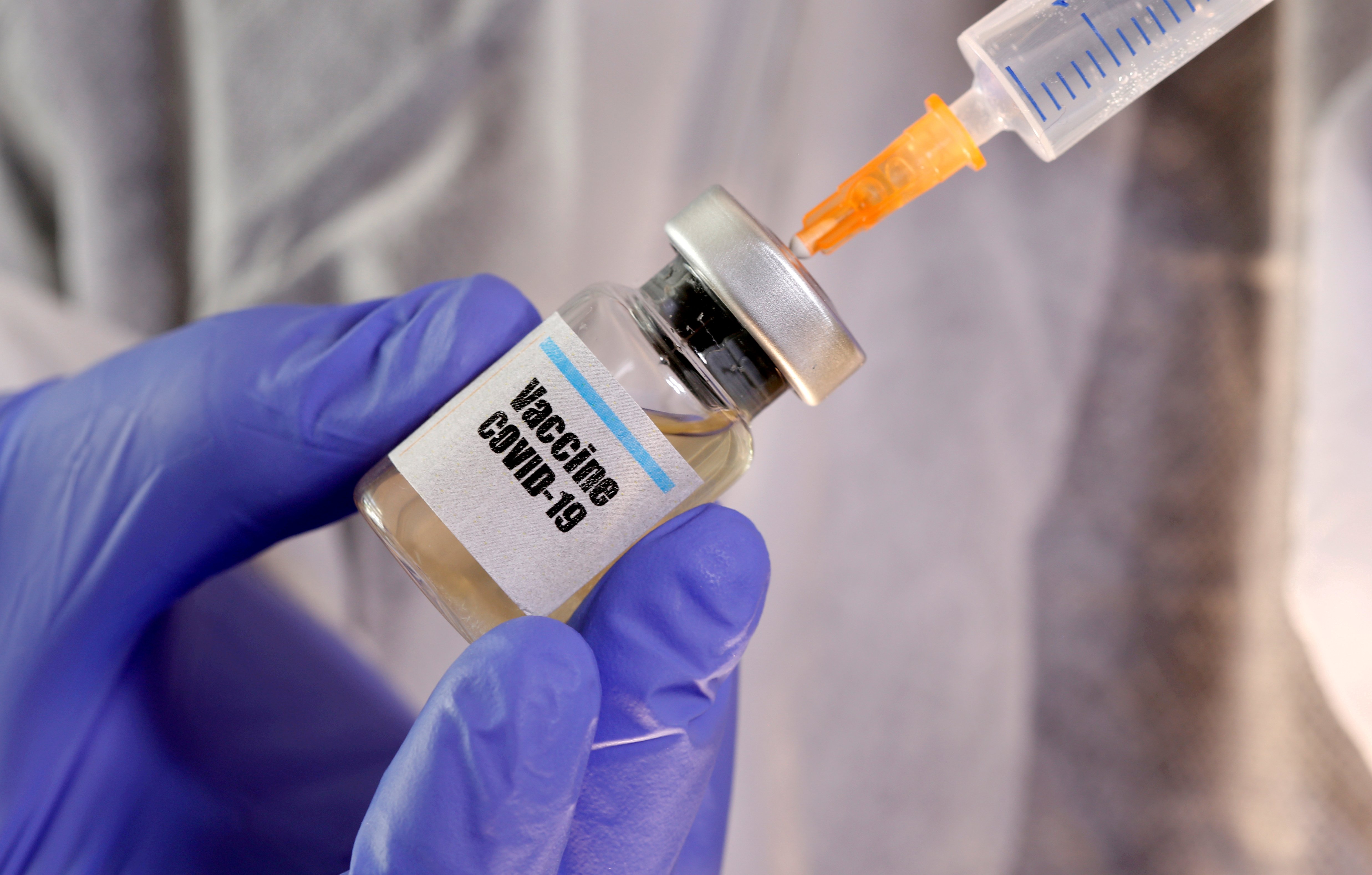 A woman models a small bottle labeled 